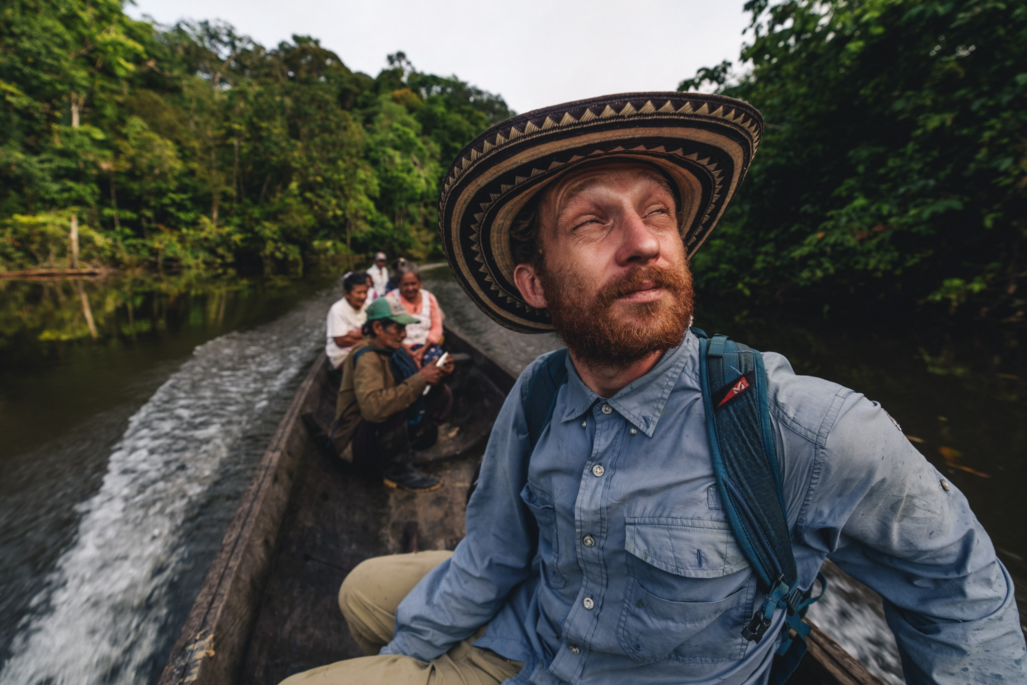 jules domine on a boat in the colombian amazon with indigenous communities
